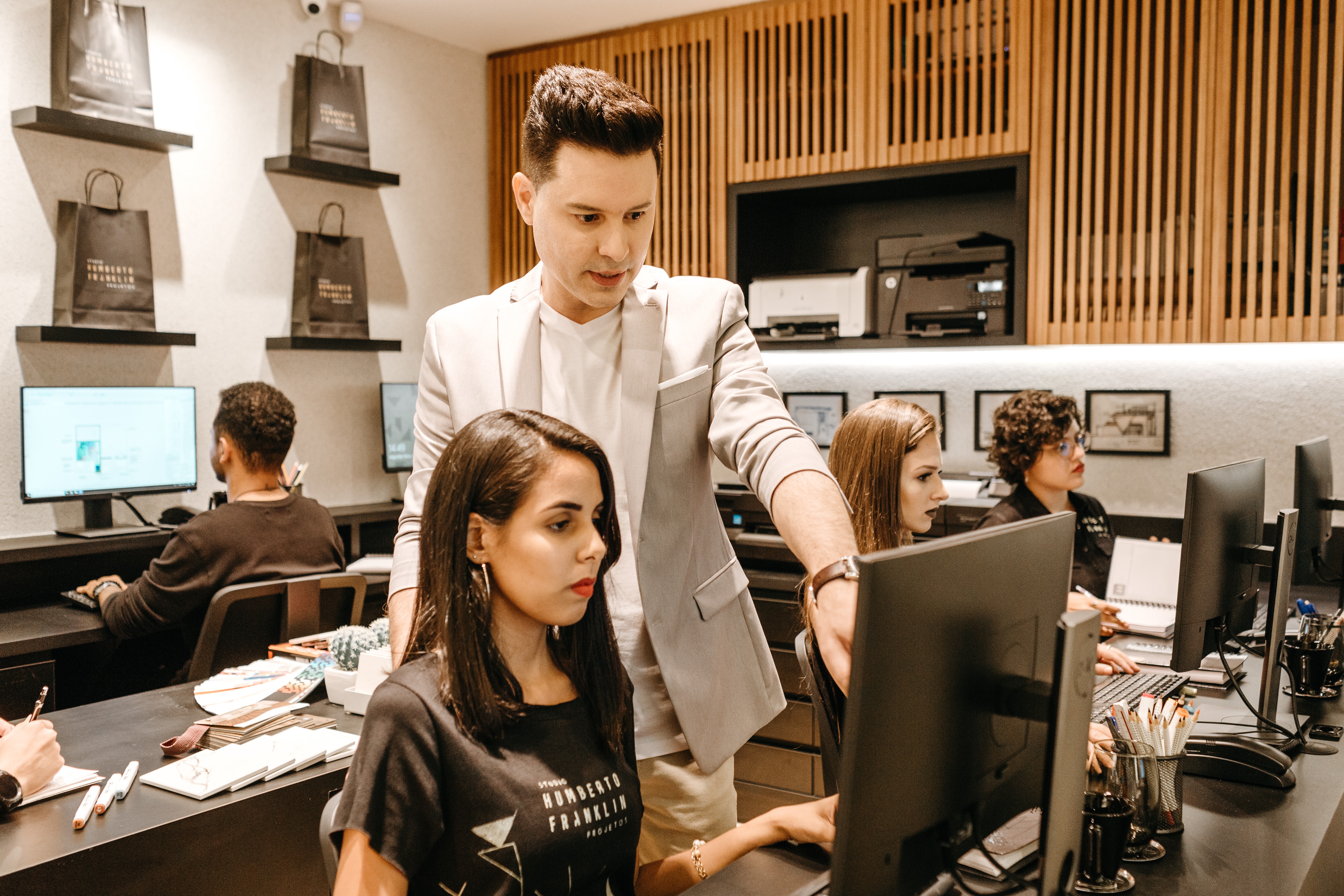 man-teaching-woman-in-front-of-monitor-3285203